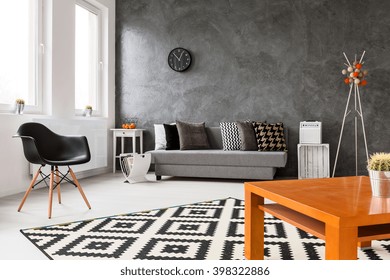 Grey Home Space With Sofa, Chair, Small Wood Table And Stylish Decorative Details