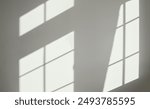 Grey interior wall background with sun light and shadows. Empty, blank grey wall bg with diagonal light and shadows from the house windows. Nobody, no people, indoor shot