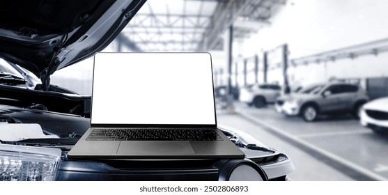 Grey laptop with blank white screen on the car engine compartment in the auto repair service garage , banner with copy space for text , Car repair and maintenance concept - Powered by Shutterstock