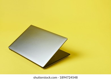 Grey Laptop Isolated On A Yallow Background. Top View With Copy Space, Flay Lay.