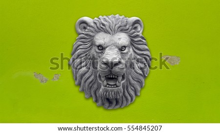 Grey Lion head statue on green wall