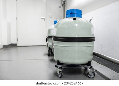 Grey liquid nitrogen tank storage with unmounted withdrawal device cryogenic hose. Metal tank or dewar