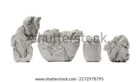 Grey modelling clay blocks, pieces isolated on white 