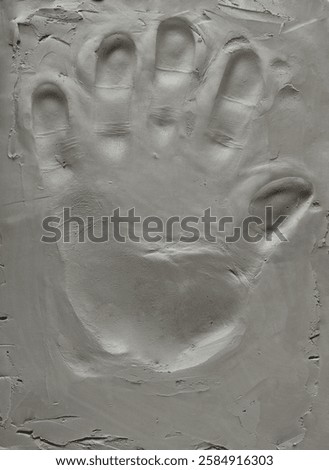 Grey modelling clay with handprint, background and texture	