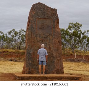 Grey Nomad Standing In Front Of Red Rock Monument To Truck Driving.