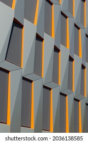Grey and Orange Cladding on a Modern Office Building. Abstract Geometric Background