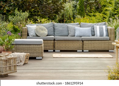 Grey Pillows On Trendy Wicker L Shape Sofa In The Green Garden