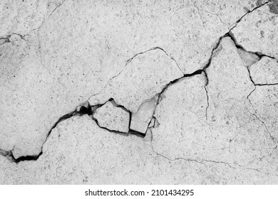 Grey plaster facade house wall with dark cracks - Shutterstock ID 2101434295
