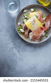 Grey Plate With Pea, Ricotta And Prosciutto Open Lasagna, Above View On A Grey Concrete Background, Vertical Shot, Copy Space