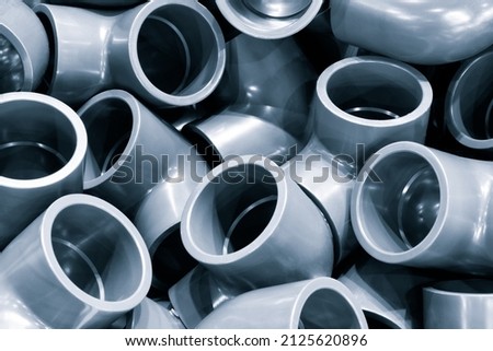 Grey pvc plumbing pipes corners background closeup