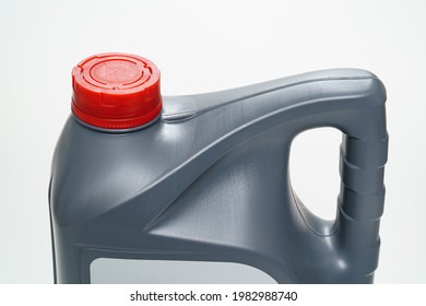 Grey With A Red Lid Canister With Machine Oil On A White Background. Motor Oils To Reduce Friction Between Moving Engine Parts. Car Service And Shop