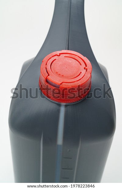 grey with a red lid canister with\
machine oil on a white background. Motor oils to reduce friction\
between moving engine parts. Car service and\
shop