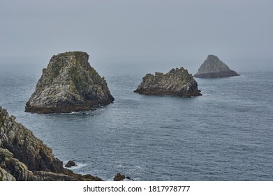 Grey rock formation in the misty atlantic ocean. Rocky islands at the coastline of Brittany, France. - Powered by Shutterstock