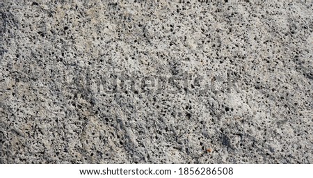 Grey rock showing its natural rough textures on surface.