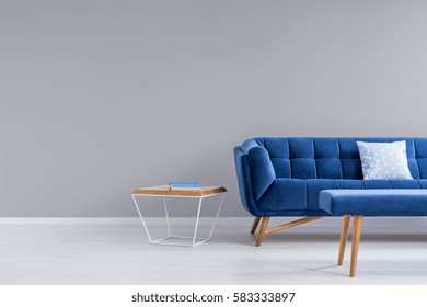 Grey Room With Blue Couch, Bench And Side Table