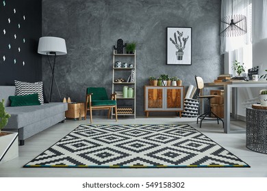 Grey room with pattern carpet and wooden furniture