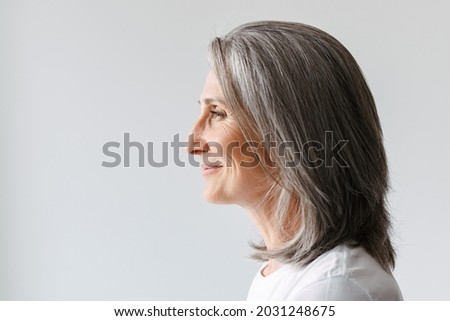 Image, Stock Photo a woman in profile in front of a meadow of flowers