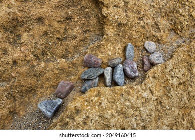 Grey Small Pebbles On Yellow Sand Stone Surface On Wild Coast Beach 