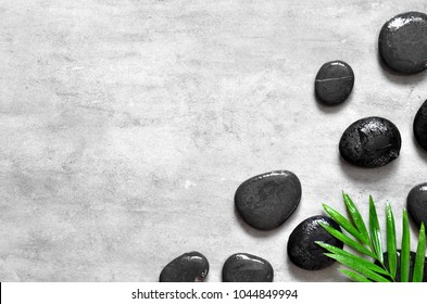 Grey Spa Background, Palm Leaves And Black Wet Stones, Top View