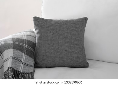 Grey Square Cushion Mockup On A White Sofa With Grey Plaid Blanket.