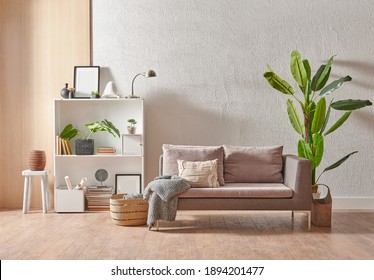 Grey stone wall interior room with wooden decor, bookshelf, sofa and vase of plant, middle table, carpet, home decoration. - Shutterstock ID 1894201477
