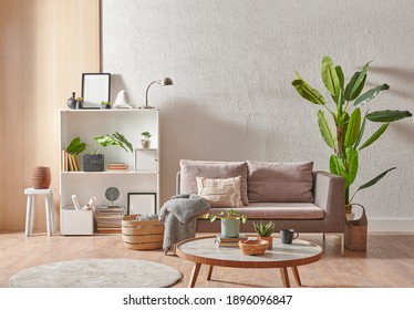 Grey Stone Wall Interior Room With Wooden Decor, Bookshelf, Sofa And Vase Of Plant, Middle Table, Carpet, Home Decoration.