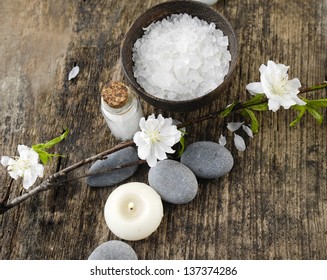 grey stones and cherry spring flower, candle ,salt in bowl on old wood - Powered by Shutterstock