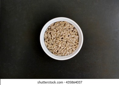 Grey Sunflower Seeds On Black Background, Overhead Horizontal View