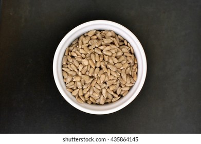 Grey Sunflower Seeds On Black Background, Overhead Horizontal View