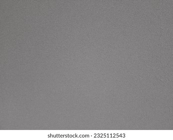 A grey surface with small dots