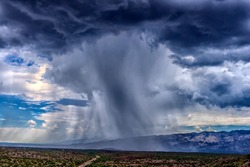 Grey Thunderhead Cloud Produces Rain Shower Over Semi-desert Grassland Prairie