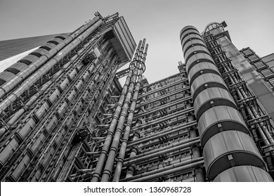 A grey towering steel pipe office structure stretched towards the London Finance district Sky like a dystopian prison.