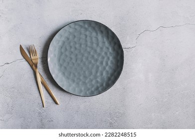 grey trendy modern empty plate with golden cutlery. Dishware collection - Shutterstock ID 2282248515