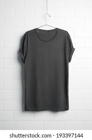 Grey T-shirt Hanging On White Wall