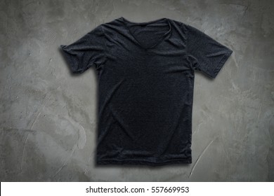 Grey t-shirt on concrete wall background.