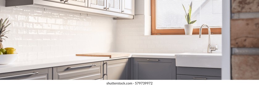 Grey units with white worktop in modern kitchen
