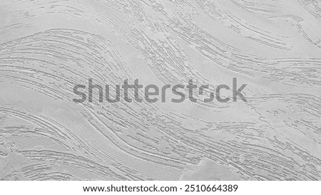 A grey wall abctract texture background with a few scratches and marks. The wall is very plain and has no decoration