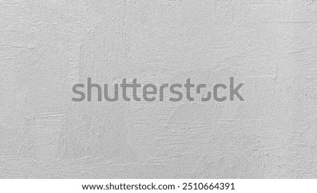 A grey wall abctract texture background with a few scratches and marks. The wall is very plain and has no decoration