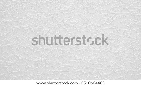 A grey wall abctract texture background with a few scratches and marks. The wall is very plain and has no decoration