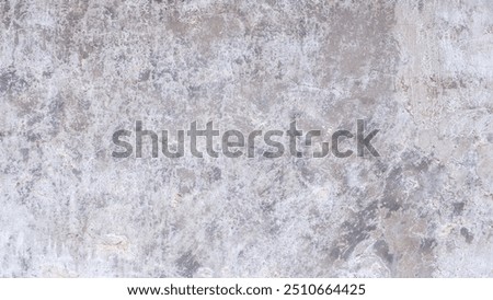 A grey wall abctract texture background with a few scratches and marks. The wall is very plain and has no decoration