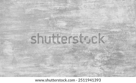 A grey wall abctract texture background with a few scratches and marks. The wall is very plain and has no decoration