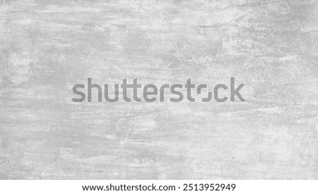 A grey wall abctract texture background with a few scratches and marks. The wall is very plain and has no decoration