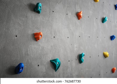 Grey Wall With Climbing Holds In Gym