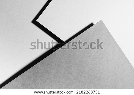 Grey and white abstract geometric background with soar triangle surfaces with corners in hard light with black shadows as monochrome stylish backdrop in elegant simple modern minimal style, top view.