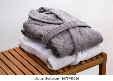 grey and white bath robes on wooden bench - Shutterstock ID 1671745516