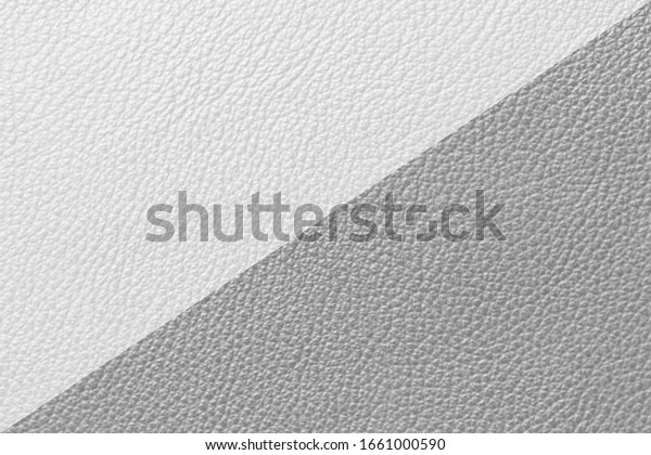 \
Grey and white leather\
texture background  divided in center creating line partition.\
Surface of leather texture in diagonal line of two tone background\
colors.\
