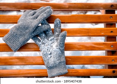 Grey Wool Mittens Glove With Snow On Winter Wood Sledge From Above. Copy Space