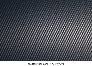 Grey woven carbon fibre composite texture background. Sheet of future light raw material. Modern technology and material concept.
