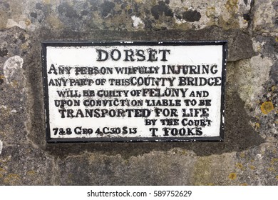 GREY'S BRIDGE, DORCHESTER, DORSET, UK: FEBRUARY 28 2017: Warning Sign On This 18th Century Bridge Warning Of Deportation As A Punishment For Damaging The Bridge.