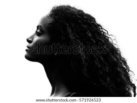 Greyscale head shot portrait in profile of a beautiful proud young woman with gorgeous curly black hair raising her head and stretching her neck over a white background
